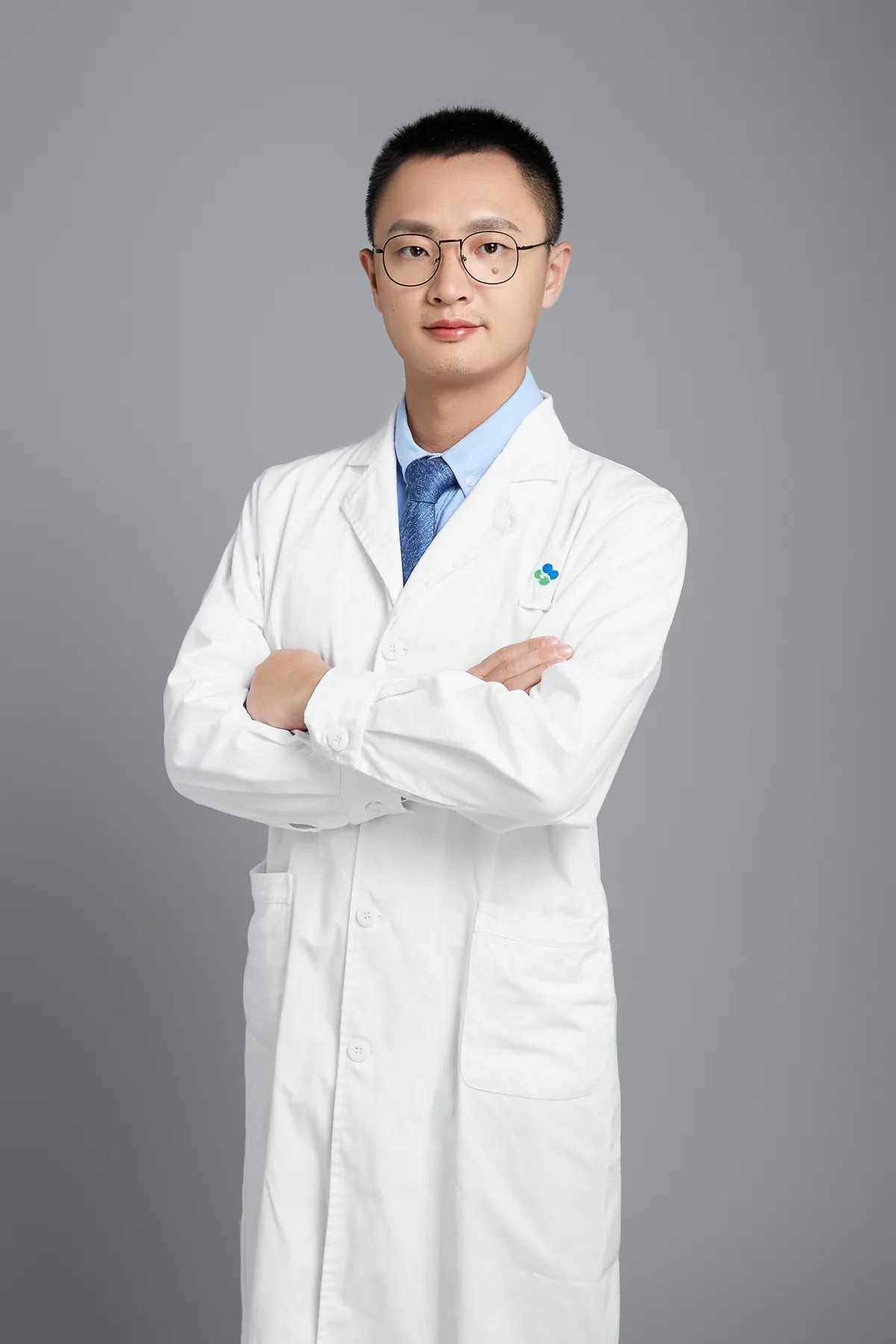 付维亮医生的个人形象照，戴眼镜、穿白大褂